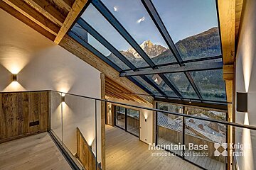 A room with a glass roof and a sign that says mountain base