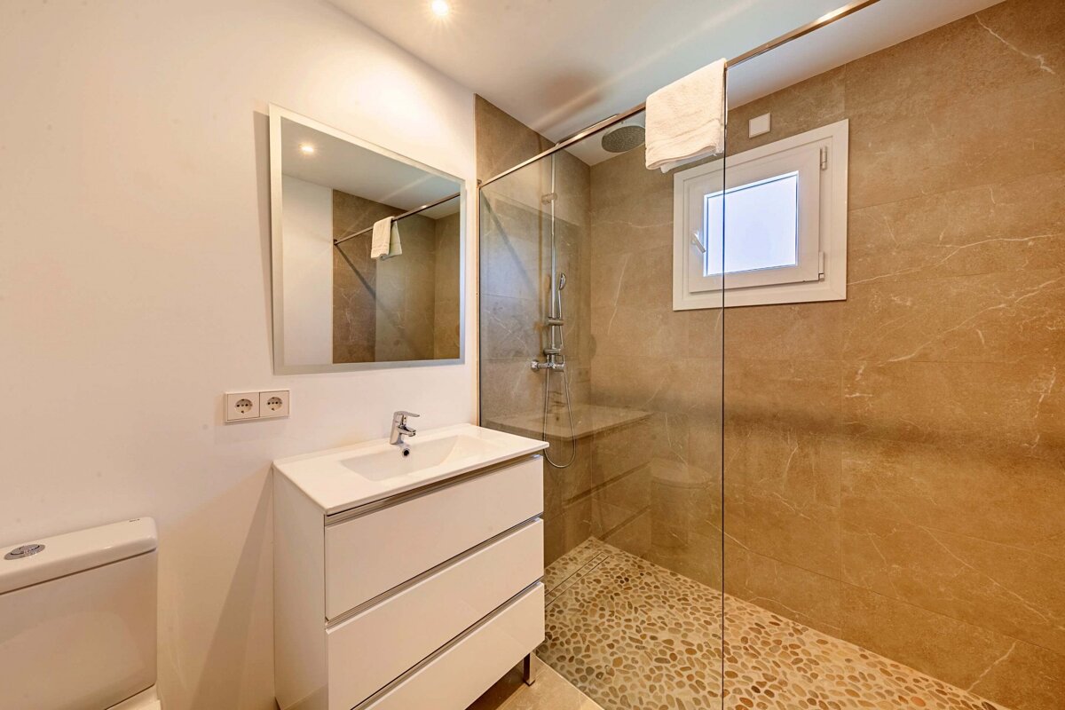 A bathroom with a sink and a walk in shower