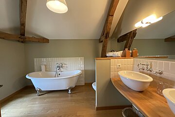 A bathroom with a claw foot tub and a sink