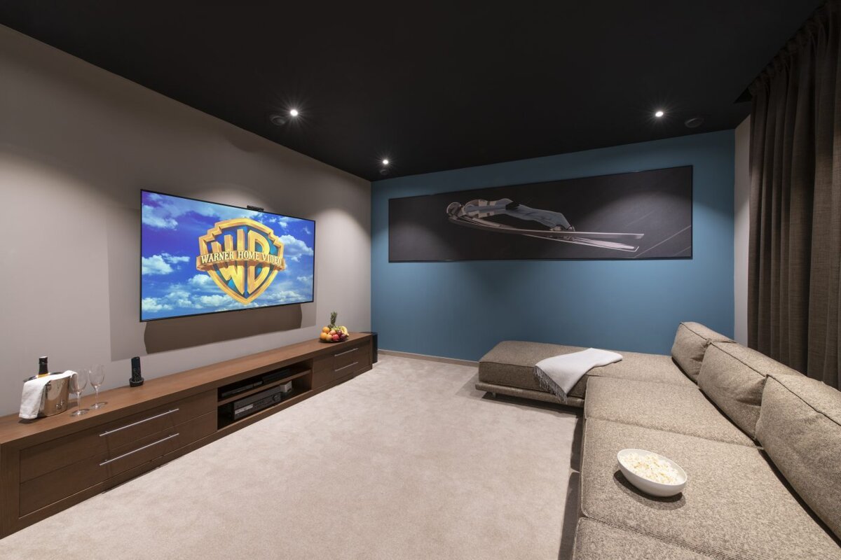A room with a couch and a tv that says ' warner bros ' on it