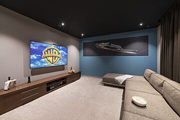 A room with a couch and a tv that says ' warner bros ' on it