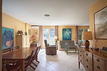 A living room with a table and chairs and a couch