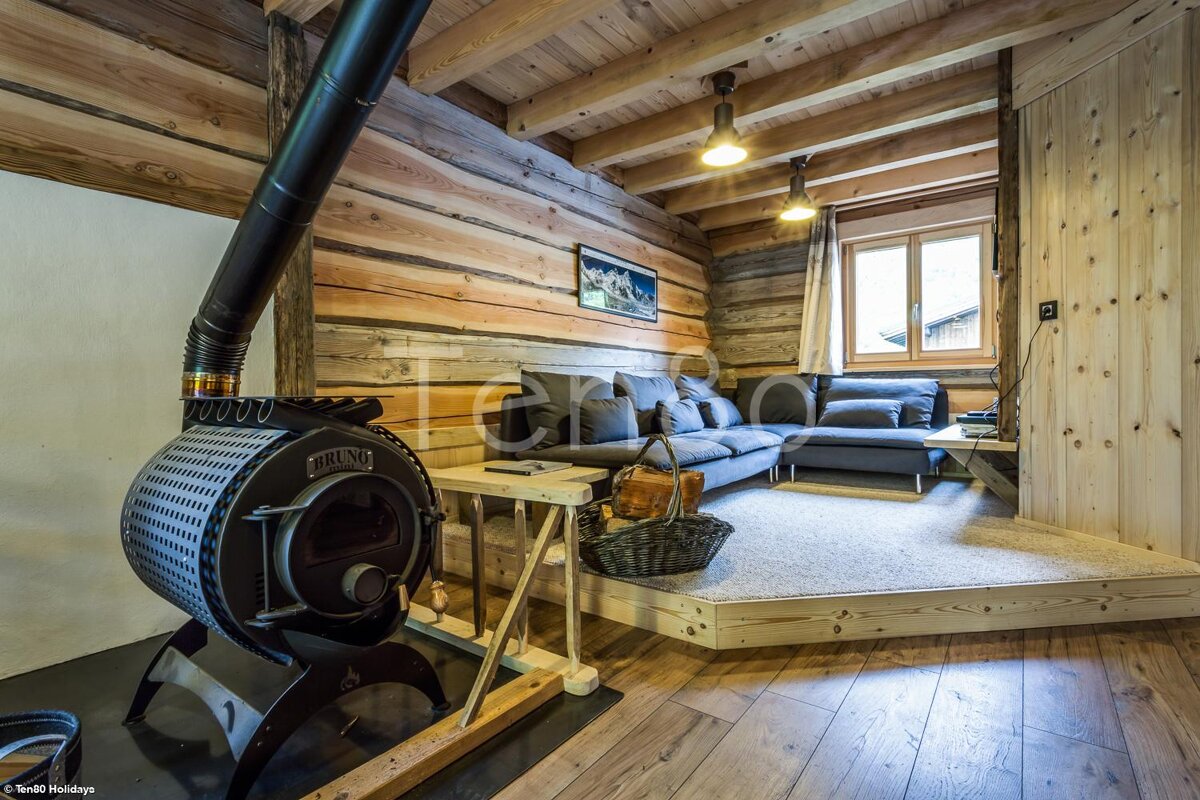 A living room with a couch and a wood stove