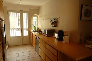 A kitchen with a microwave and a coffee maker