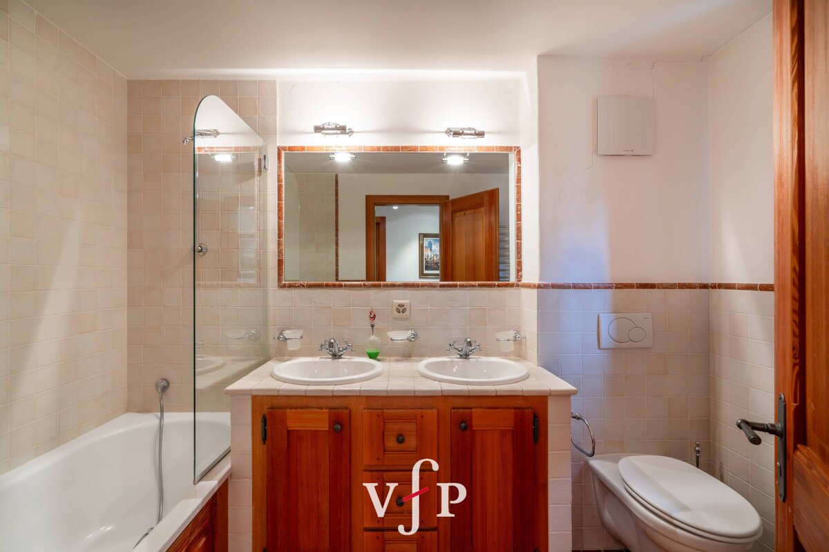 A bathroom with two sinks and a toilet with vfp written on the bottom