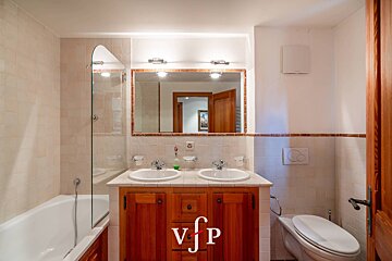 A bathroom with two sinks and a toilet with vfp written on the bottom