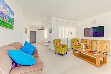 A living room with two chairs and a flat screen tv
