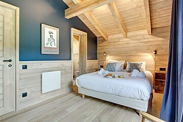 A bedroom with a bed and a poster on the wall that says jean michel