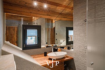 A bathroom with a sink and a mirror that says vjp