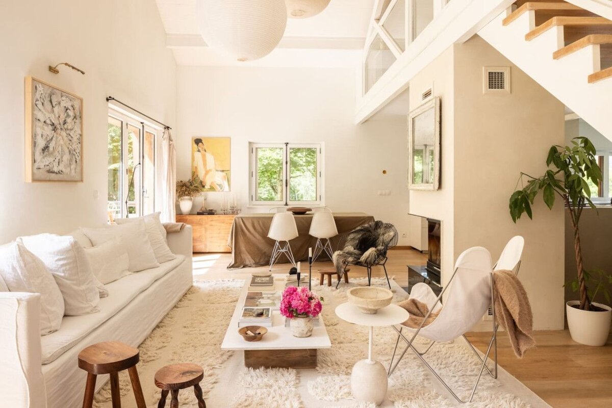 A living room with a white couch and a white coffee table