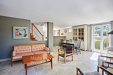 A living room with a couch and a table that says made in provence by immobilier