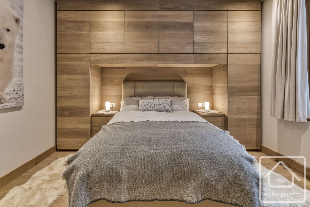 A bedroom with a bed and a picture of a polar bear on the wall