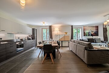 A kitchen with a table and chairs and a couch