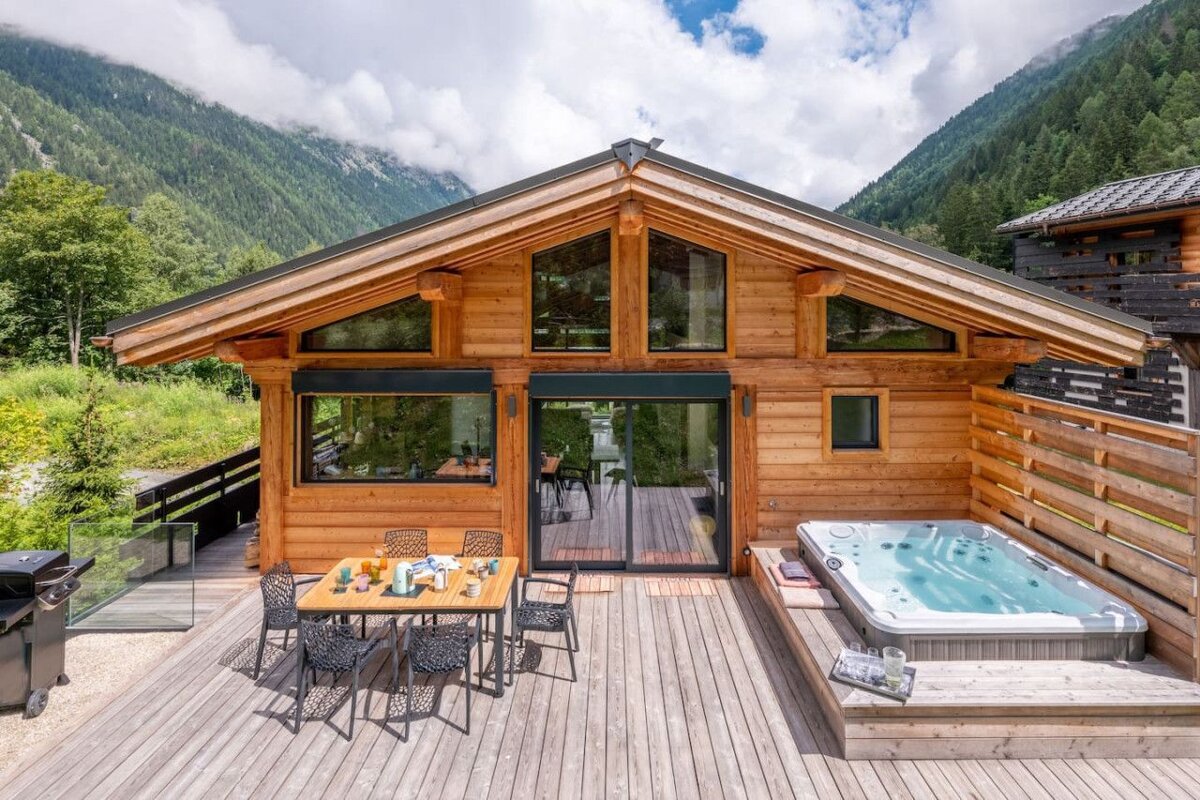 A wooden house with a hot tub in front of it