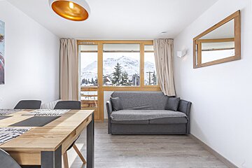 A living room with a couch and a table that says appetit