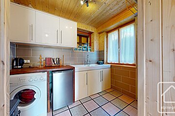 A kitchen with a washing machine and a dishwasher