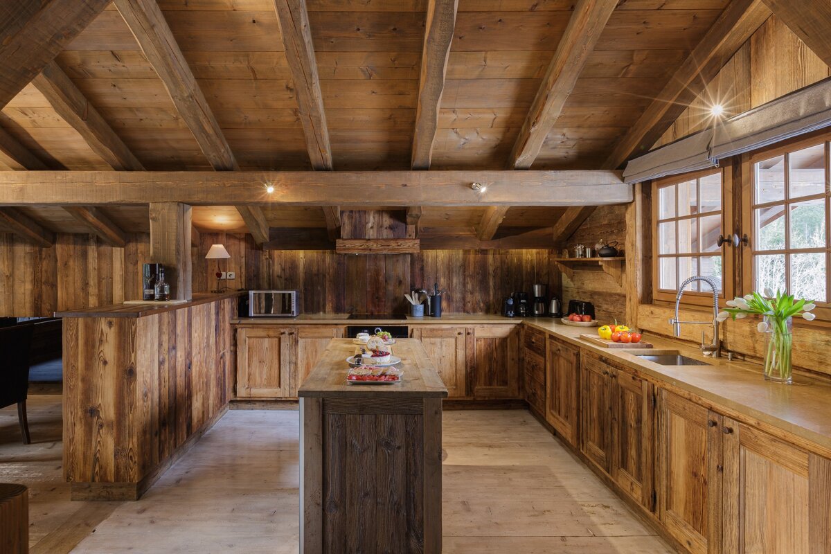 A kitchen with wooden cabinets and a sink