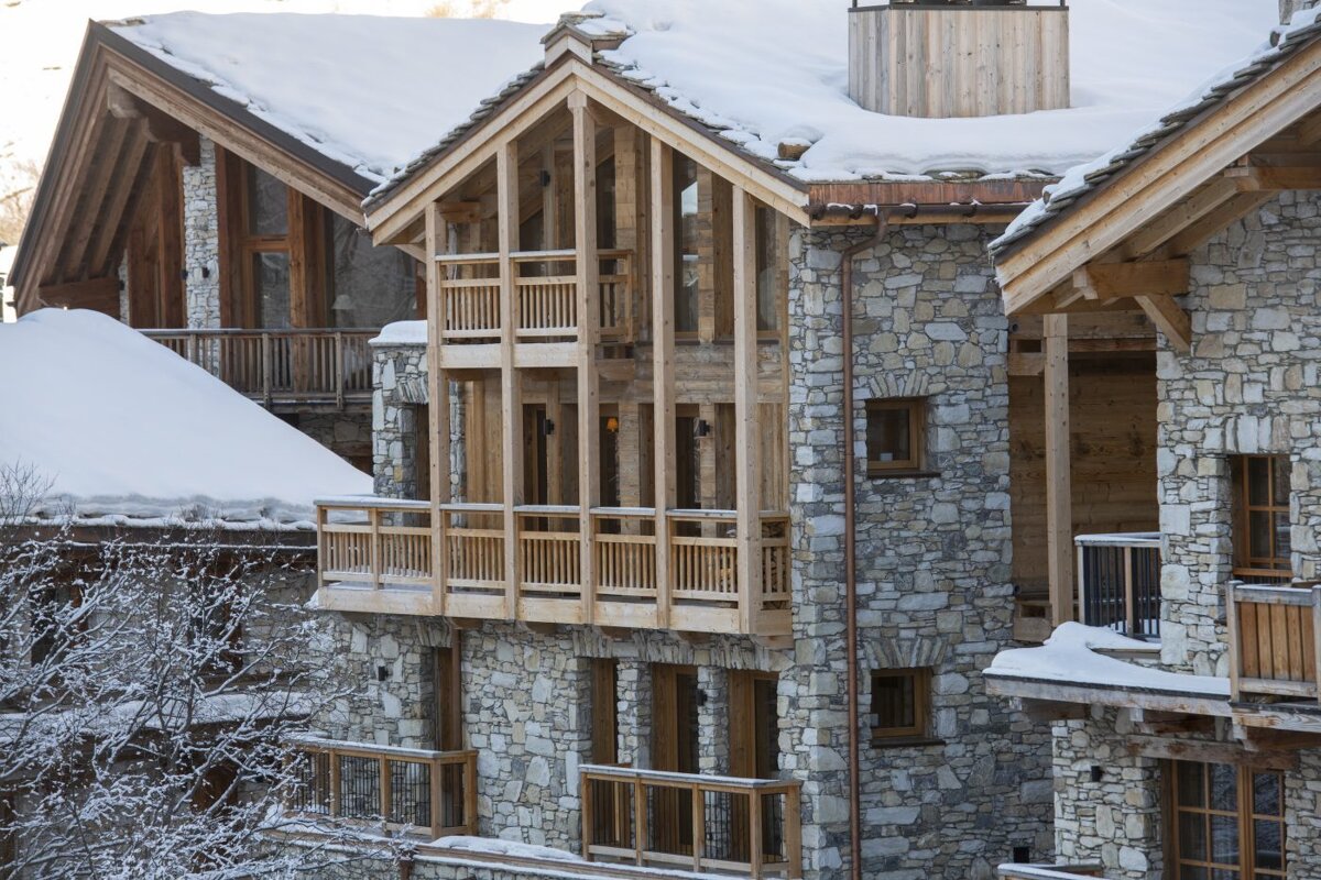 A stone building with a wooden roof and balconies
