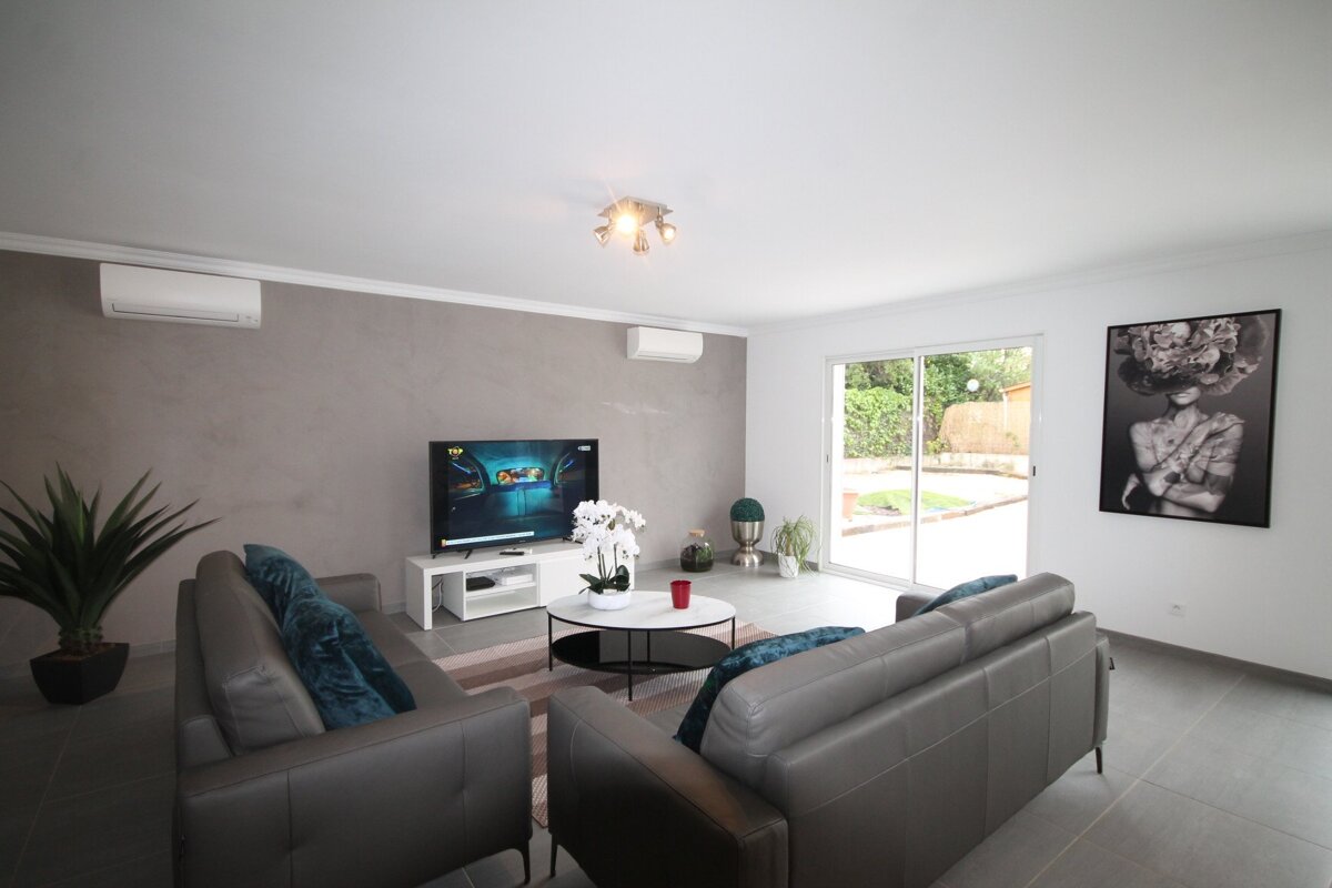 A living room with two couches and a flat screen tv
