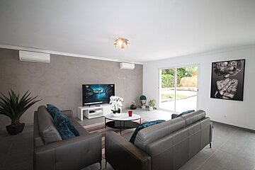 A living room with two couches and a flat screen tv