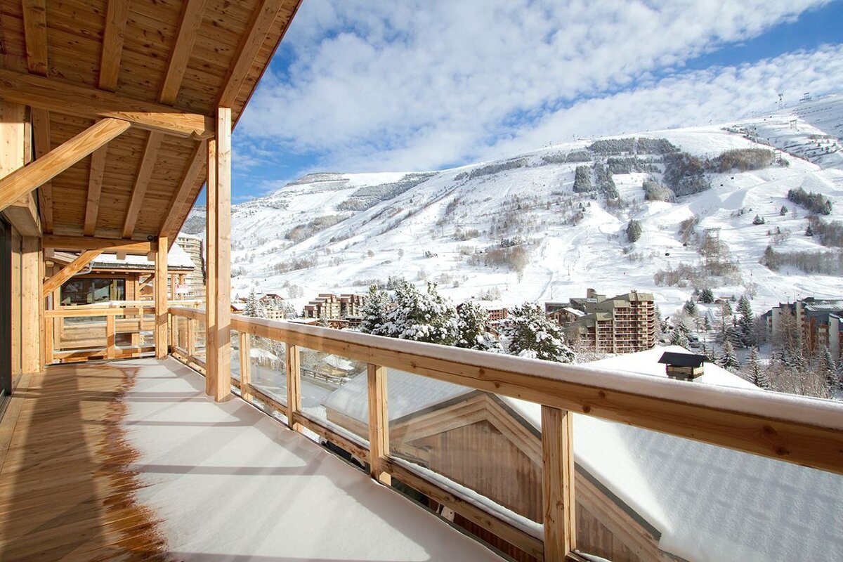 A balcony with a view of a snowy mountain