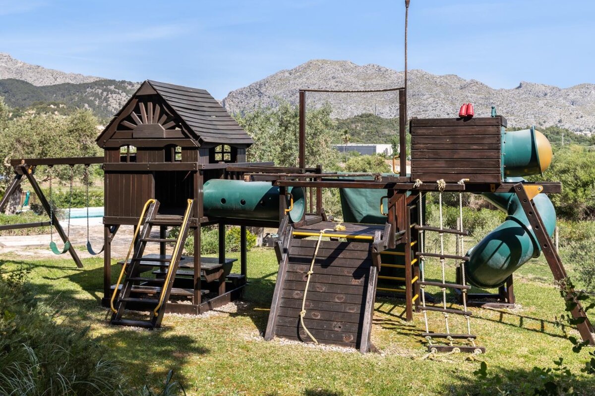 A wooden playground with mountains in the background