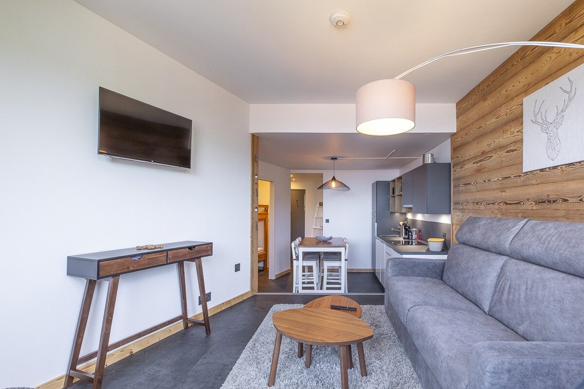 A living room with a couch and a flat screen tv