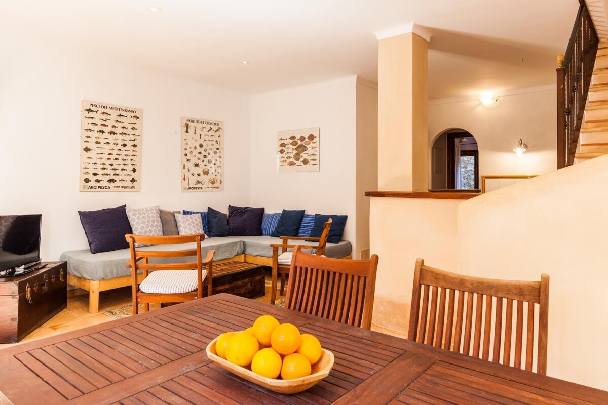 A wooden table with a bowl of lemons on it