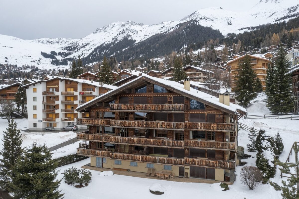 A large building with a red sign that says ' swiss ' on it