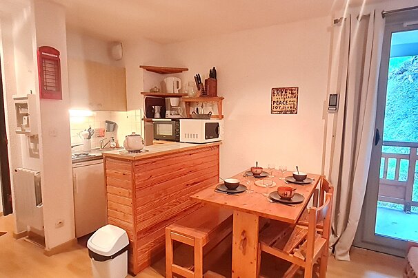 A kitchen with a sign on the wall that says love