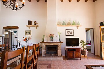 A living room with a fireplace and a flat screen tv