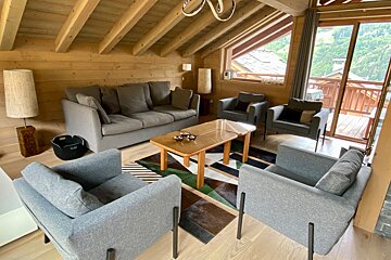 A living room with a couch and two chairs