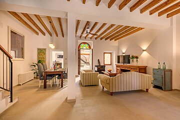 A living room with wooden beams and a stained glass window