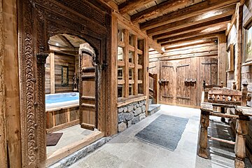 A wooden room with a bathtub in it