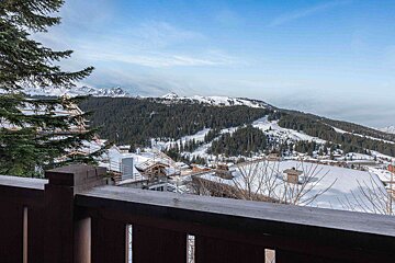A view of snow covered mountains from a balcony