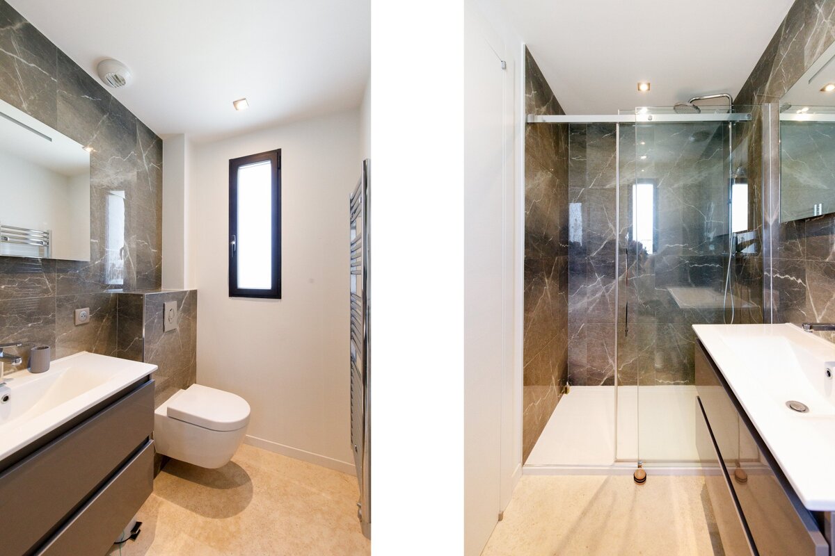 A bathroom with a toilet a sink and a walk in shower