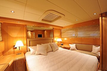 A bedroom with a large bed and a couch