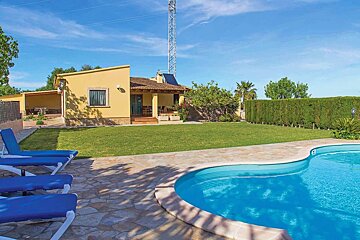 A house with a swimming pool in front of it