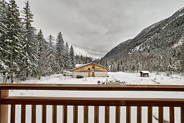 A view of a snowy mountain from a balcony