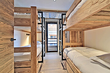A bedroom with bunk beds and a window