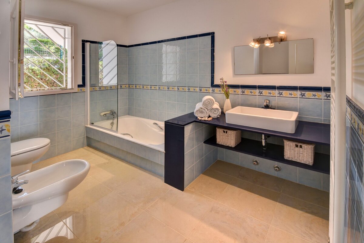 A bathroom with a sink toilet and bathtub