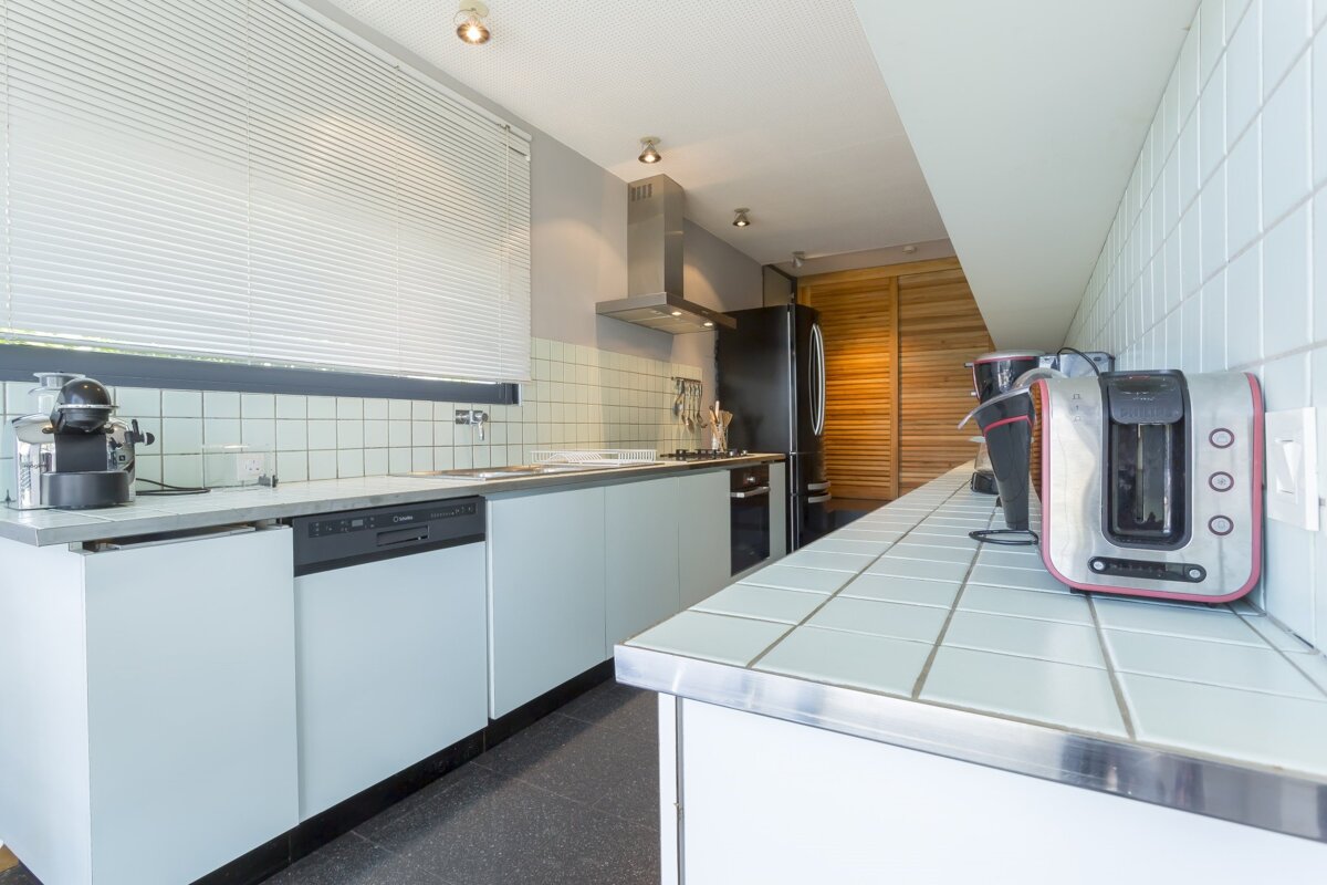 A kitchen with a toaster that says bosch on it