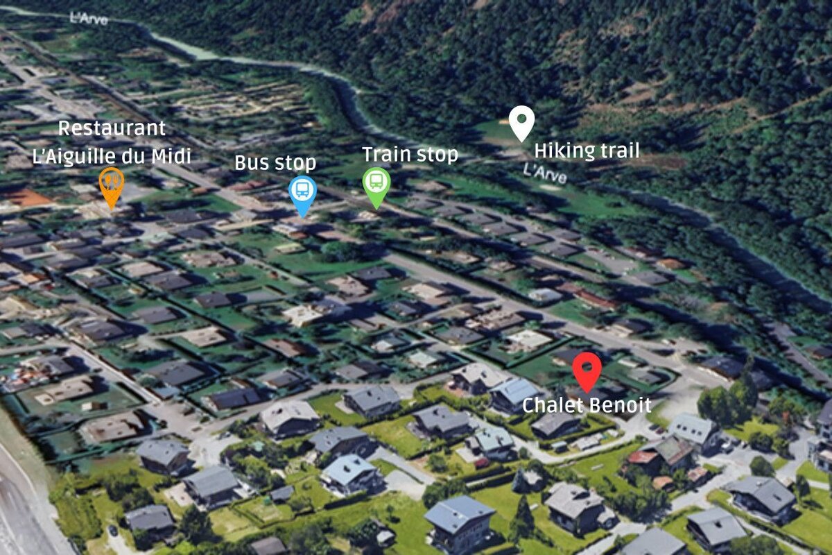 An aerial view of a residential area with the words restaurant l' aiguille du midi bus stop train stop and hiking trail