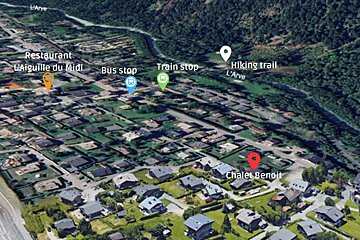 An aerial view of a residential area with the words restaurant l' aiguille du midi bus stop train stop and hiking trail