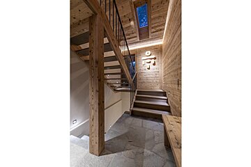 A wooden staircase leading up to the second floor of a house