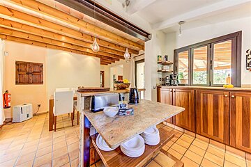 A kitchen with wooden cabinets and a toaster