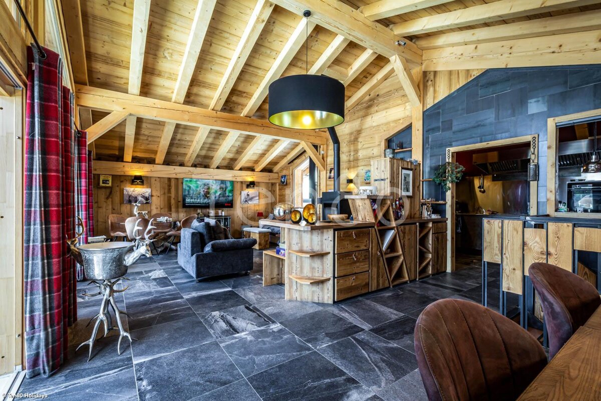A living room with a black lamp hanging from the ceiling