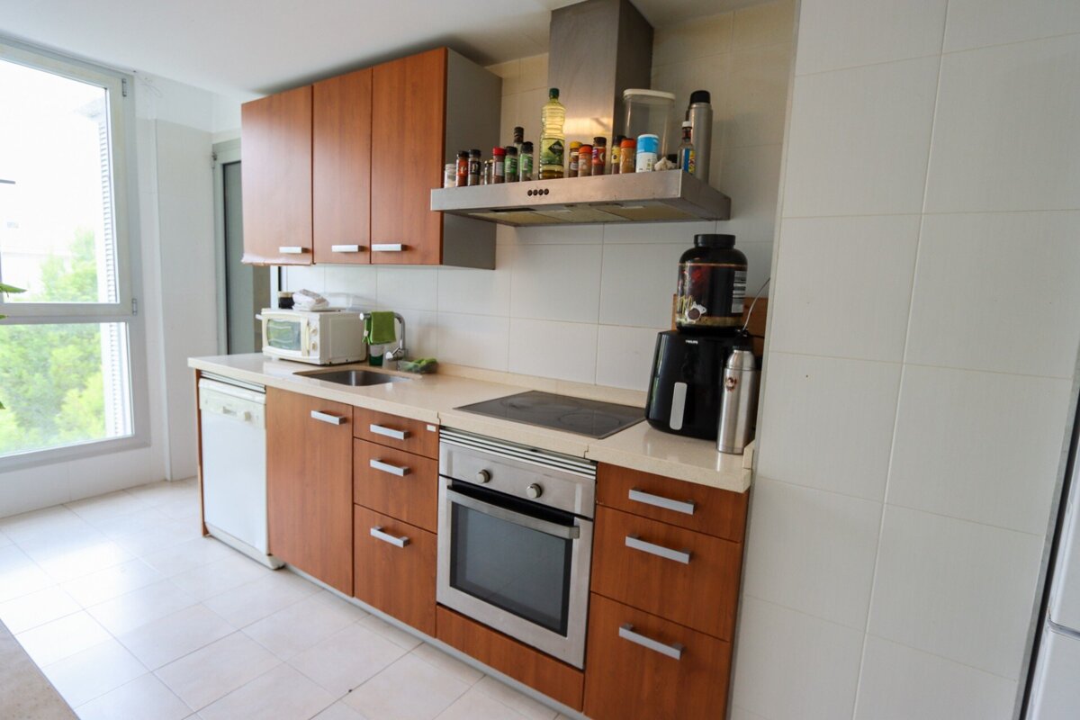 A kitchen with wooden cabinets and a stove top oven
