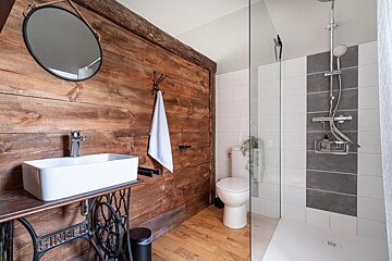 A bathroom with a sewing machine sink and toilet