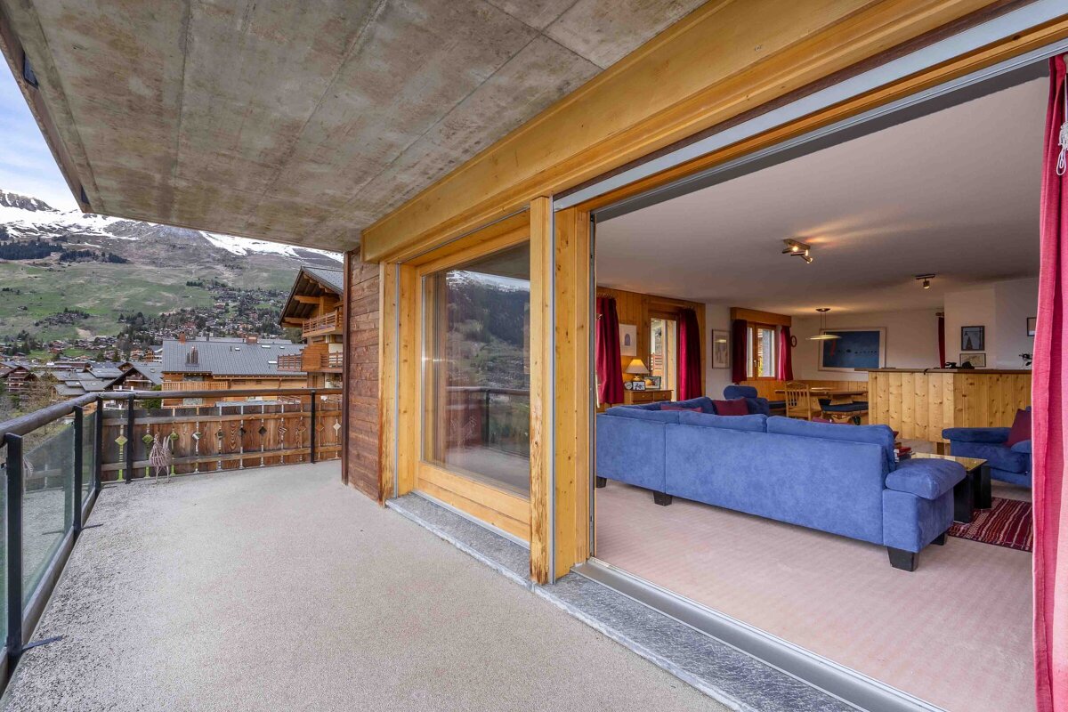 A living room with a blue couch and red curtains